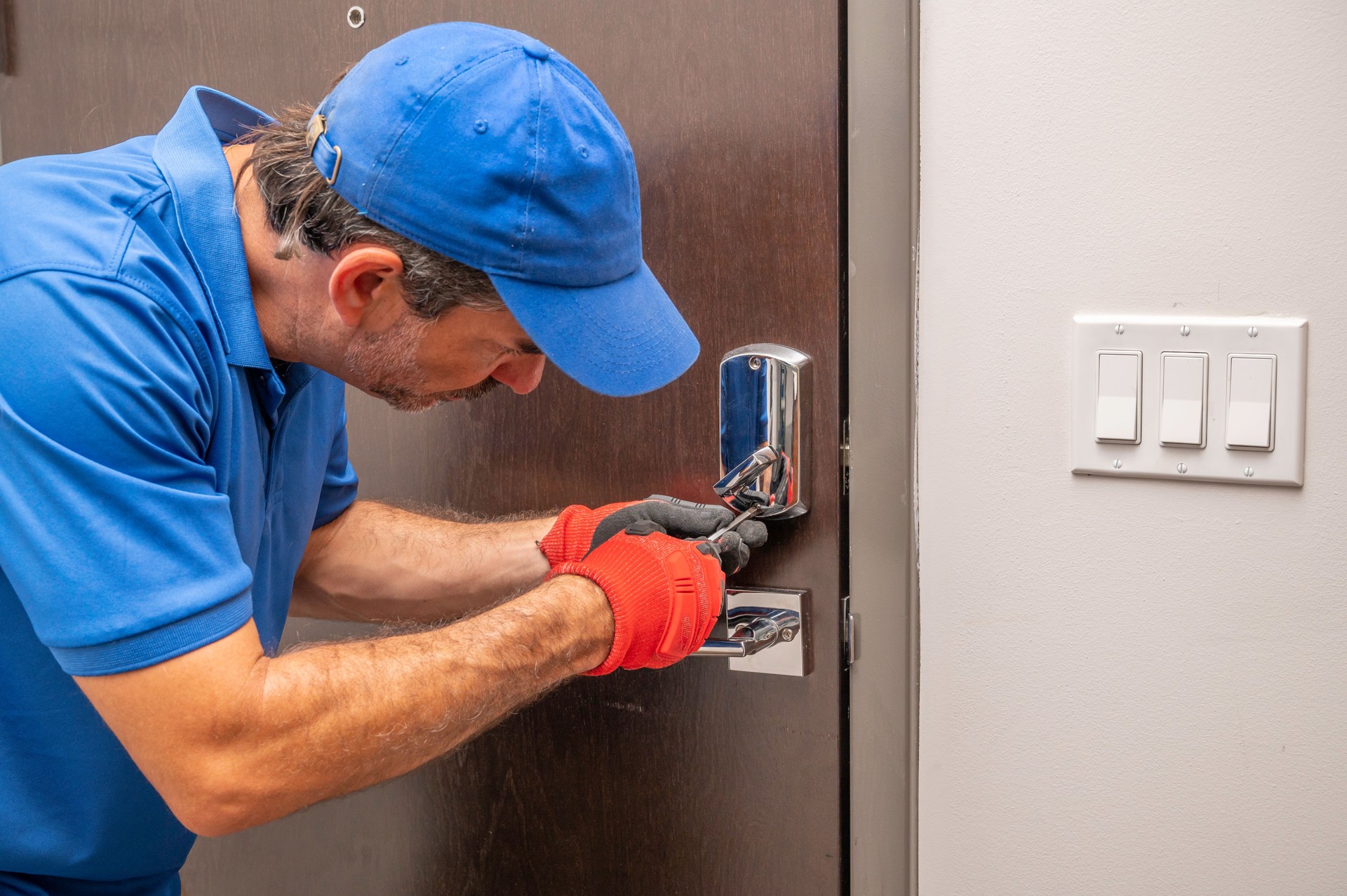Locksmith working on deadbolt lock
